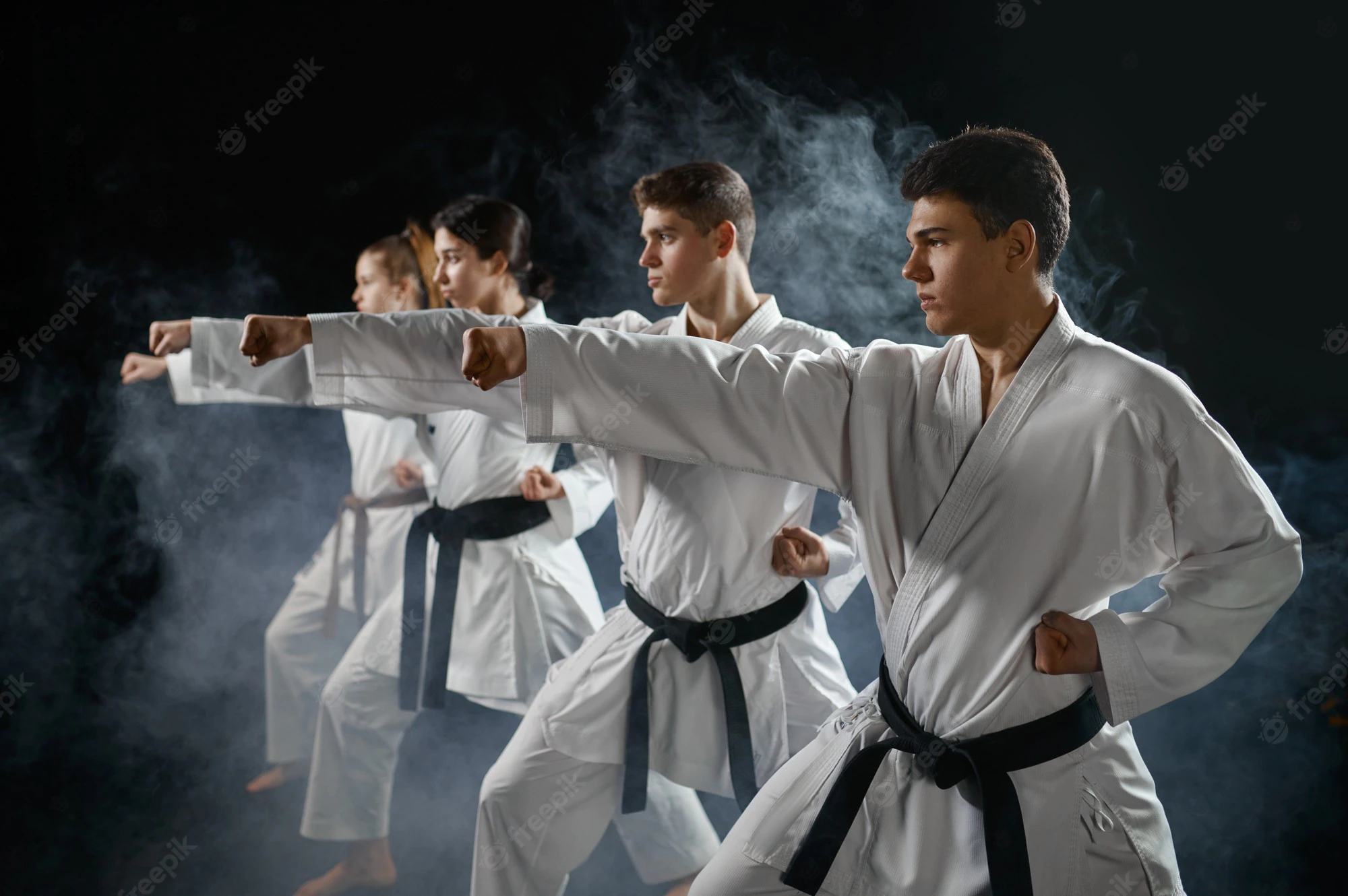 four-karate-fighters-poses-white-kimono-group-training-karatekas-workout-martial-arts_266732-21075
